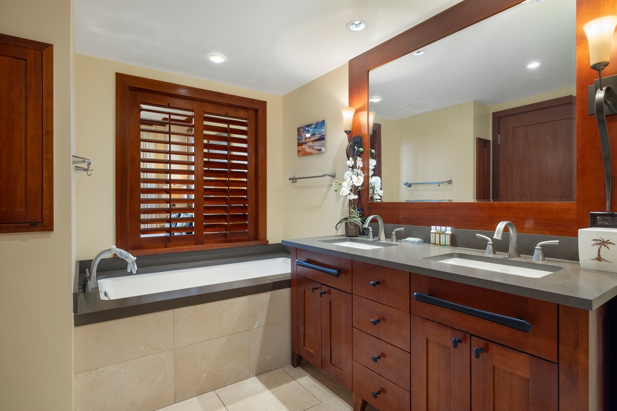 Bathroom with dual vanities and a soaking tub.