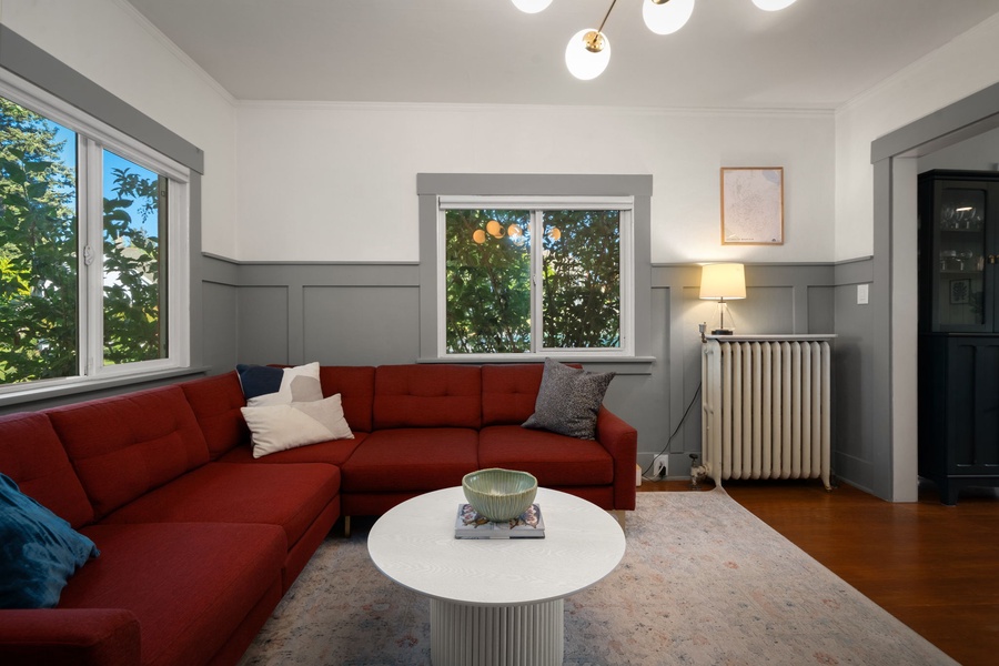 Unwind in the bright living room with cozy seating and neighborhood views outside.