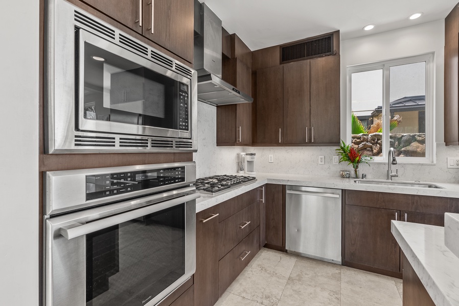 Fully-stocked kitchen with stainless steel appliances.