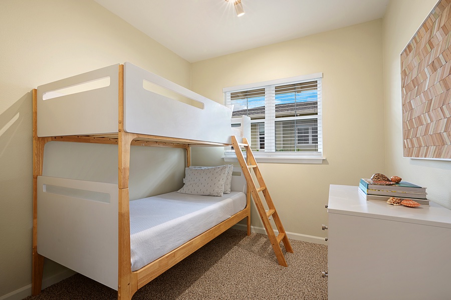 The den bunk room has barn doors and space for two guests.