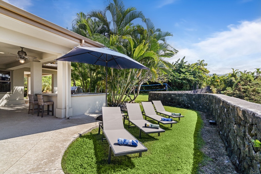 Poolside loungers surrounded by vibrant landscaping, ideal for sunbathing and relaxation.