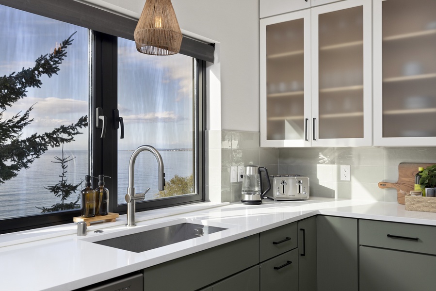 Coastal charm meets functionality — enjoy morning coffee with a view from the kitchen window.