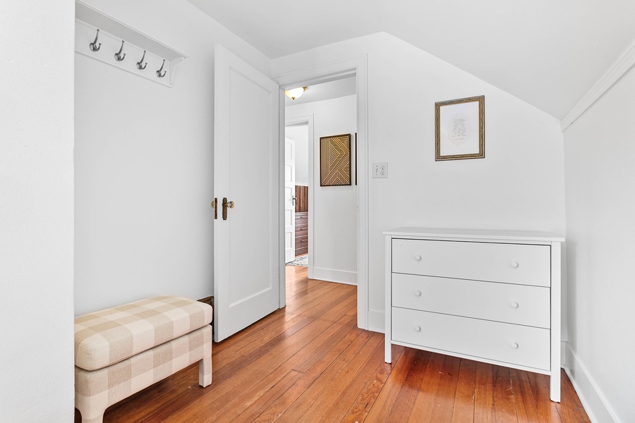 A welcoming upper landing connects guest rooms and includes a charming dresser nook.