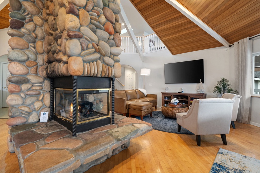 Unwind in your cozy living room where a stunning stone fireplace creates the perfect ambiance for relaxing evenings with loved ones.