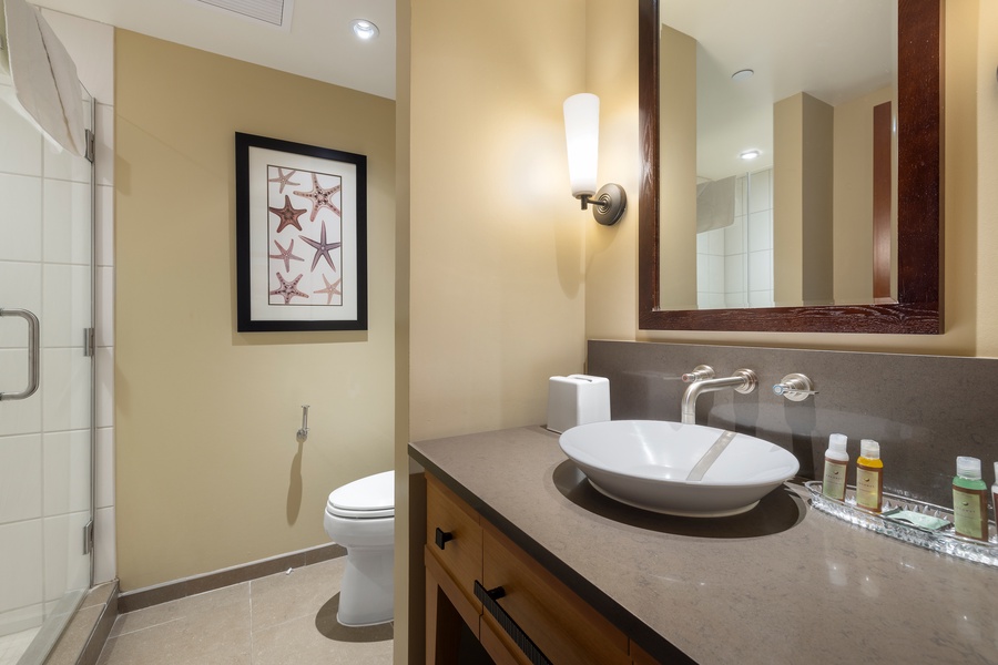 Step into your elegant bathroom featuring warm coastal touches and modern amenities for a refreshing start to your day.