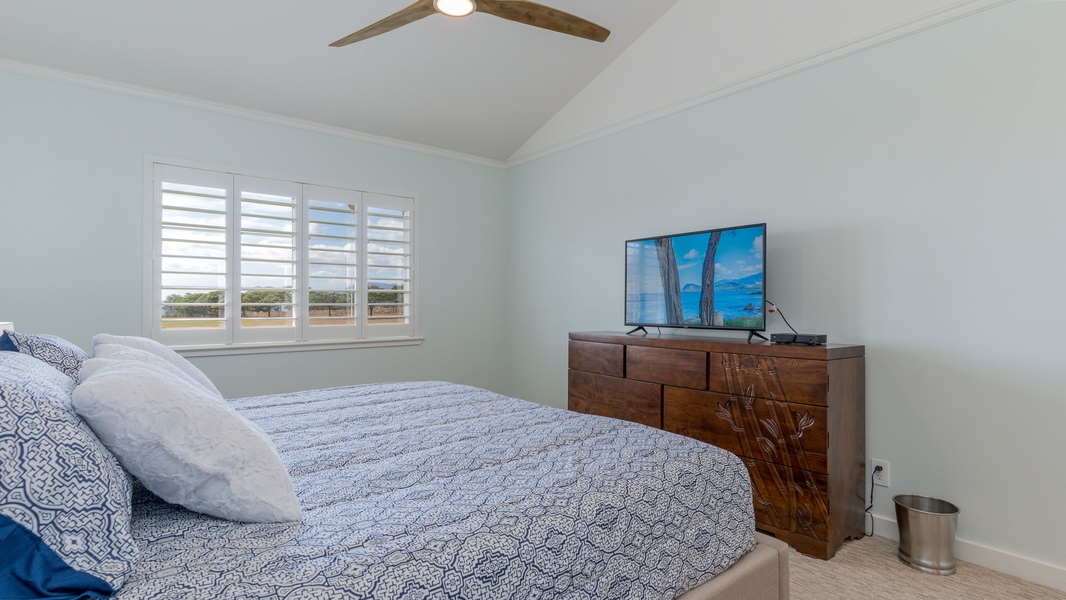 The primary guest bedroom includes a dresser and television.