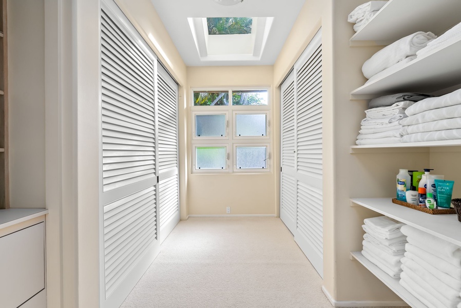 Features abundant storage, fresh linens, and natural light streaming through the skylight above.