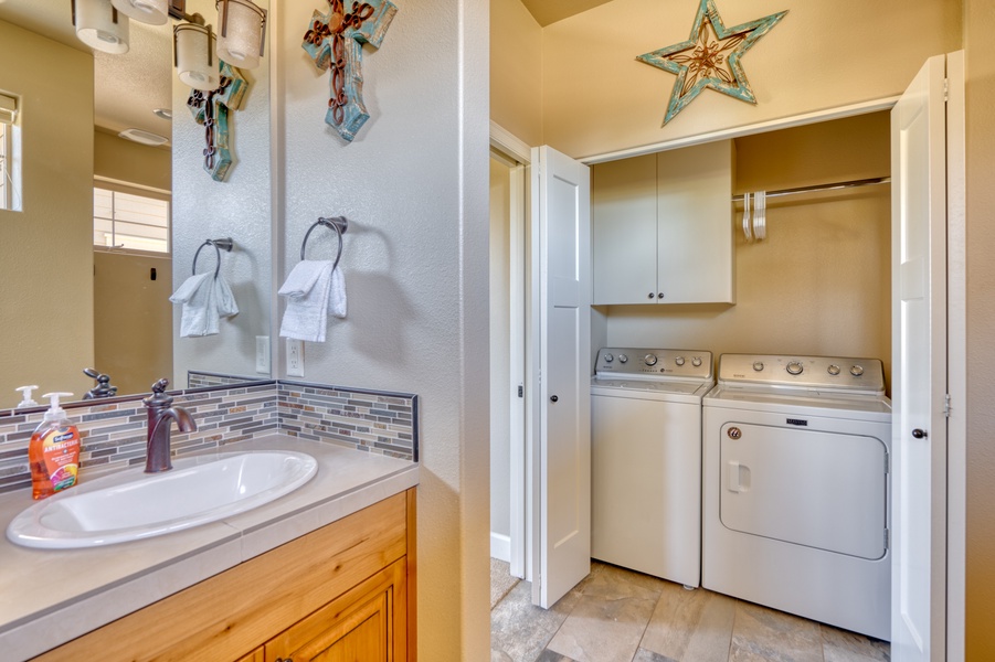 Behind the closet doors in the ensuite bathroom, discover the convenience of a washer and dryer for your laundry needs