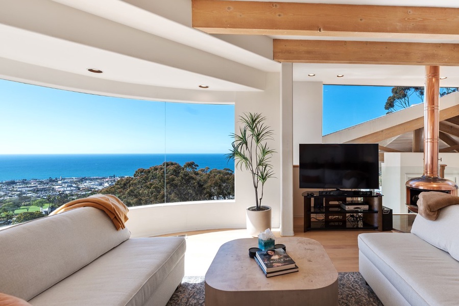 Family room with copper fireplace, HD Smart TV, and amazing ocean views with a private veranda