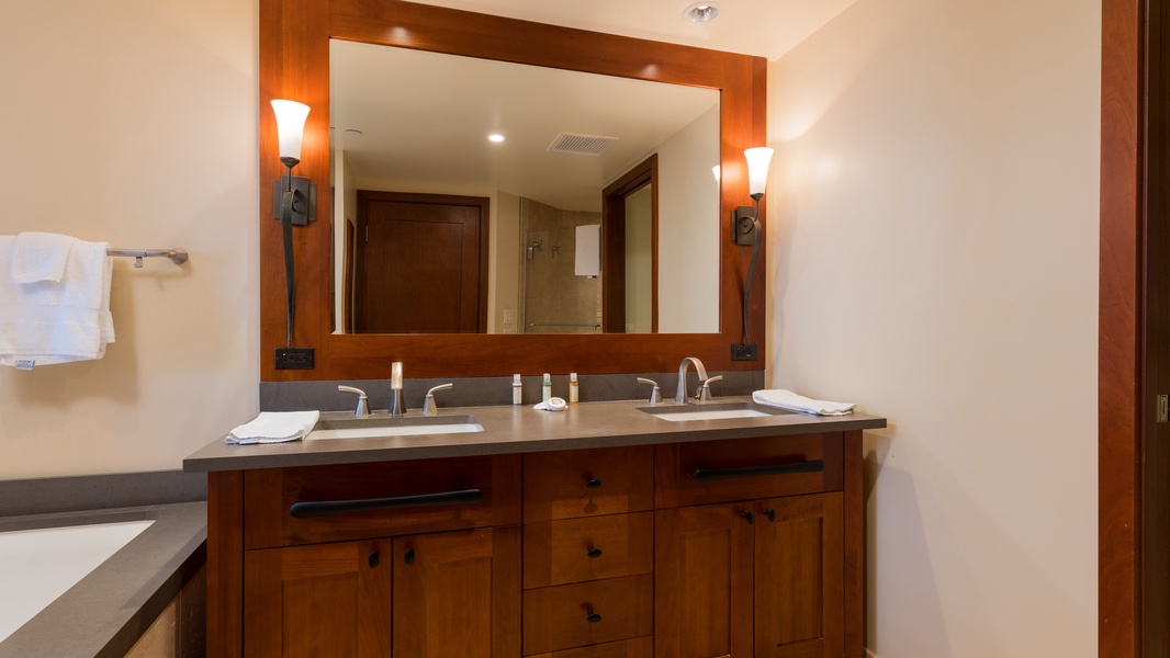 The primary guest bathroom with a double vanity and warm wood tones.