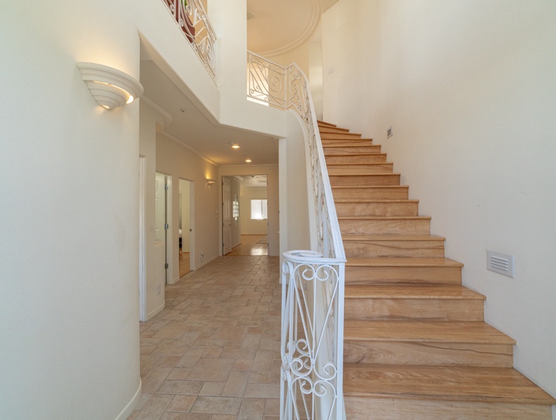 A captivating view of the first-floor bedrooms and the staircase leading to the primary floor