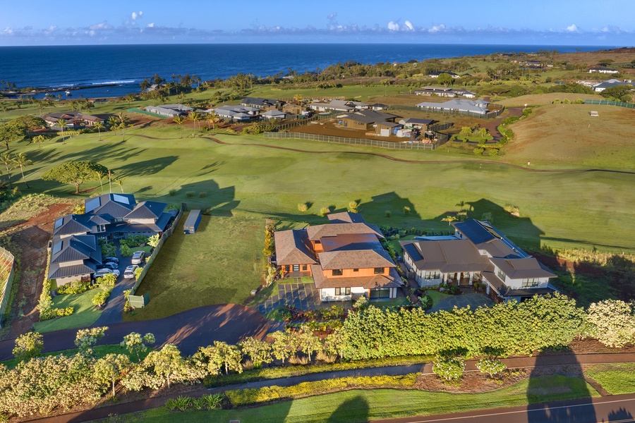 Expansive estate perspective with ocean horizon and neighboring greens.