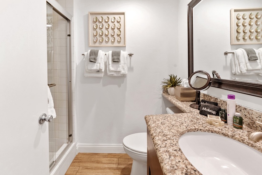 Down the hall, you'll find the guest bathroom, which features a step-in shower/tub with sliding glass doors.