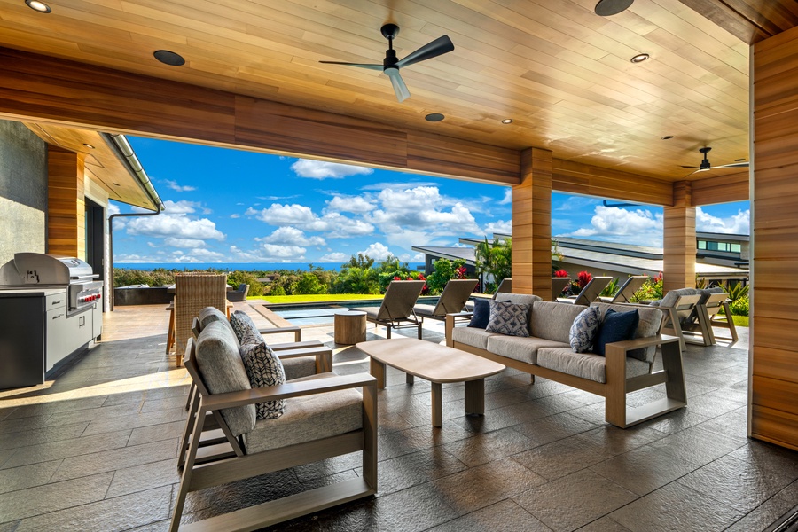 Relax in your covered outdoor living space with plush seating and stunning ocean views framing every moment of your stay.
