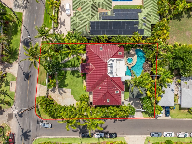 Aerial view of the property with boundaries marked, showcasing the spacious grounds and private pool.