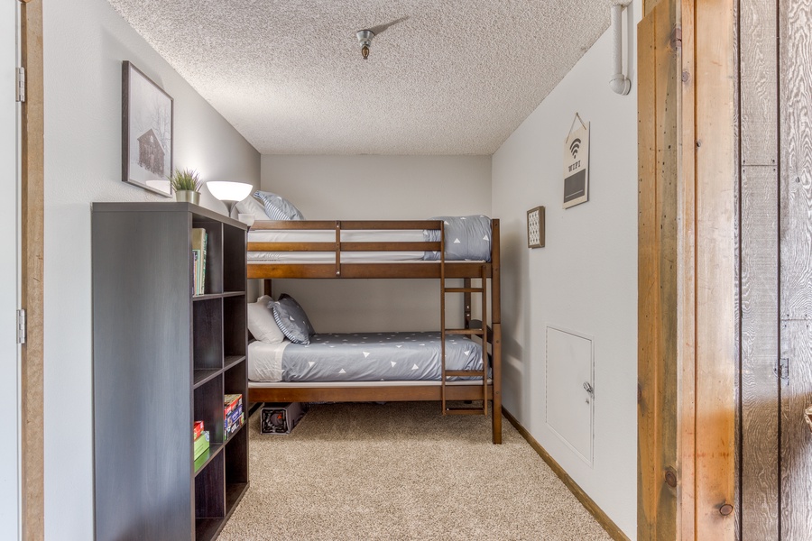 Twin bunk beds right off dining area perfect for little ones