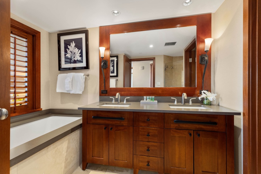 Spacious ensuite with tub, twin sinks, and expansive vanity.