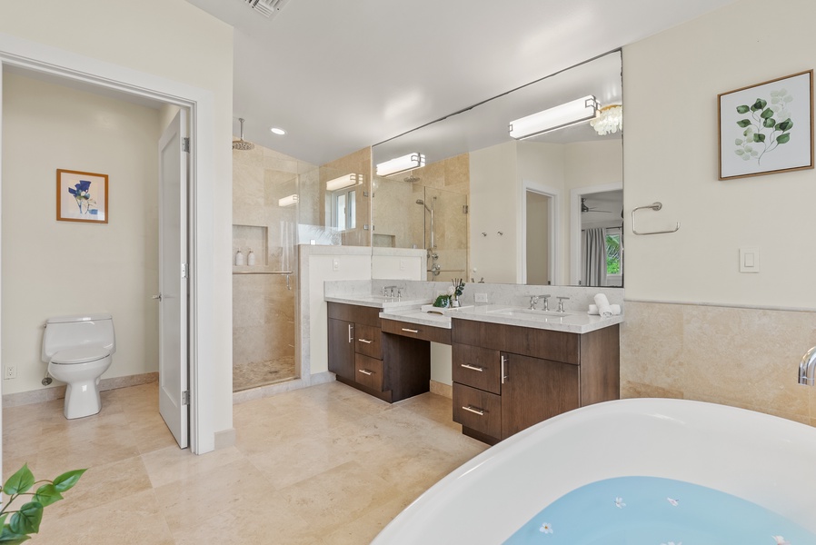 The spa-like ensuite bathroom with a spacious vanity area and a separate shower.