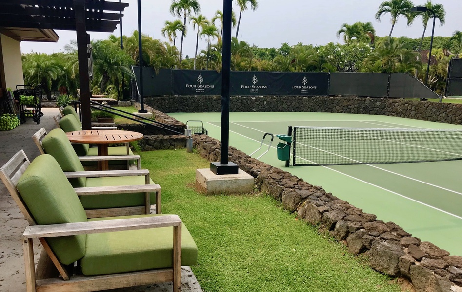 Relax courtside in plush green seating while watching tennis matches or planning your next game at the Hualalai Resort tennis courts.