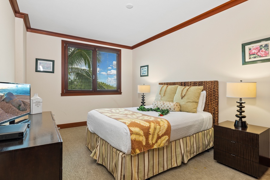 The second guest bedroom with an queen bed in an elegant setting.