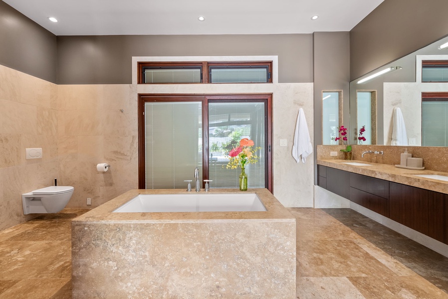 The ensuite bath offers a large soaking tub and ample vanity area.