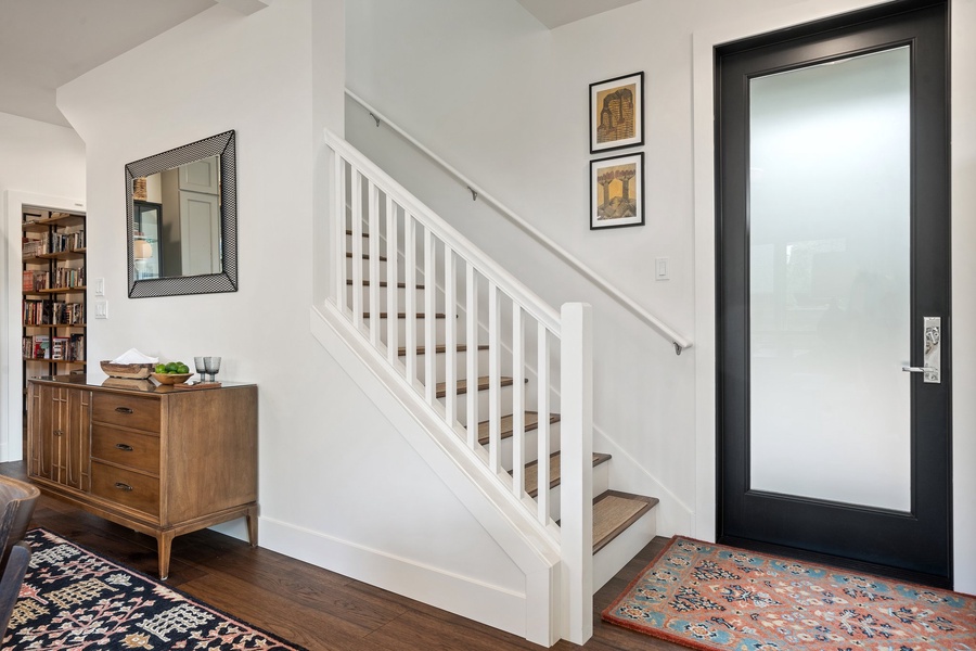 A warm welcome at The Black Squirrel—entryway with rug, hooks, and plenty of Northwest charm.