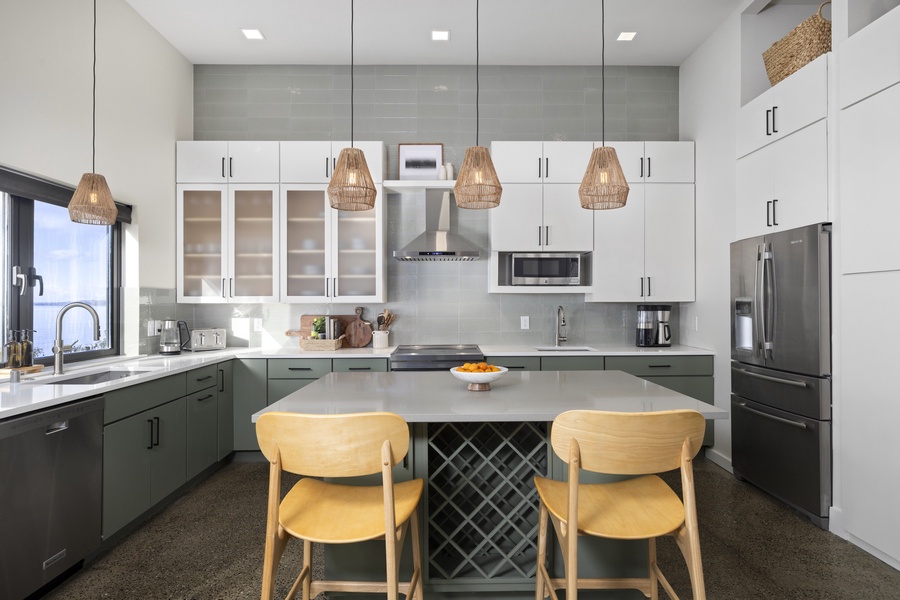 Beautifully styled kitchen with pendant lighting, stone countertops, and bar seating for casual dining.