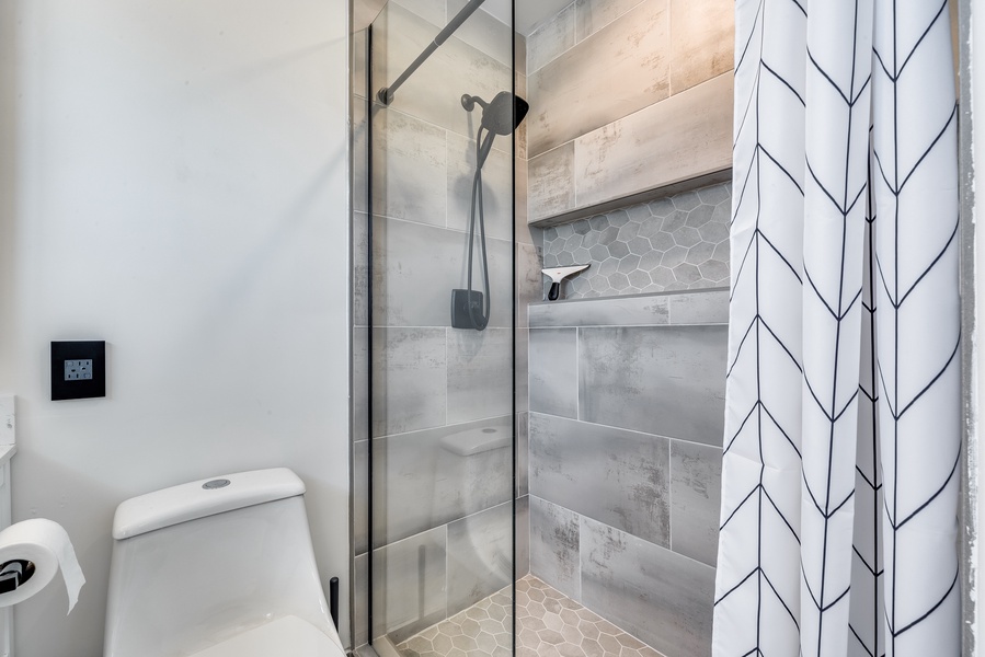 Clean, white-finish bathroom with a walk-in shower.