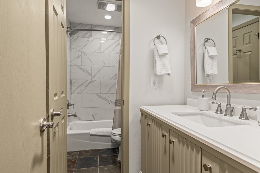 Ensuite bathroom comes with a wide vanity space and a shower/tub