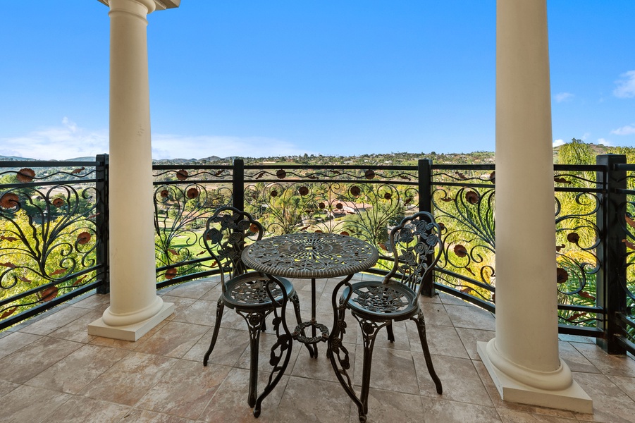 Out on a private balcony, a bistro table and the valley do all the talking.