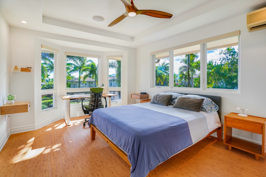 Wake up to tropical palm views from your bright corner bedroom, complete with workspace and cooling ceiling fan for ultimate comfort.