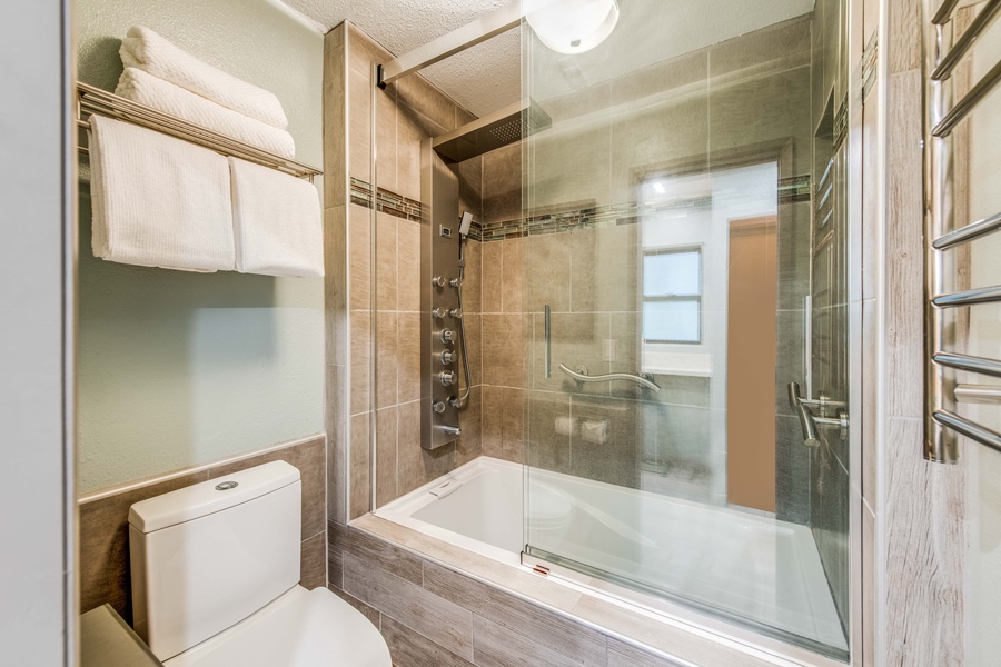 Relax and recharge in the elegant ensuite with a spa-like bath and multi-functional shower for a truly indulgent experience.