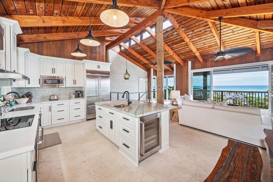 Gourmet kitchen overlooks living with panoramic landscape views