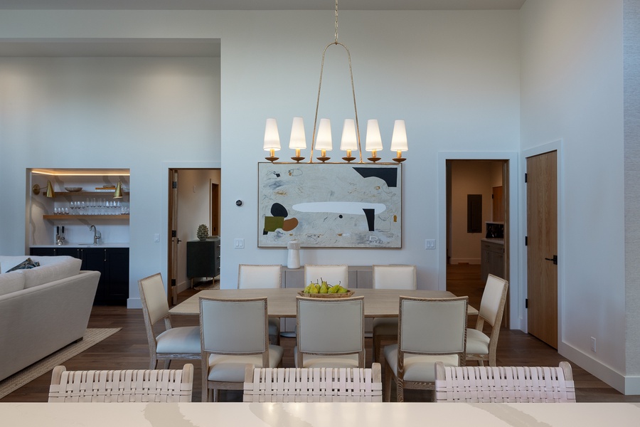 Contemporary dining space accented by an abstract art piece and elegant pendant lighting, offering a chic backdrop for memorable meals and shared moemnts.