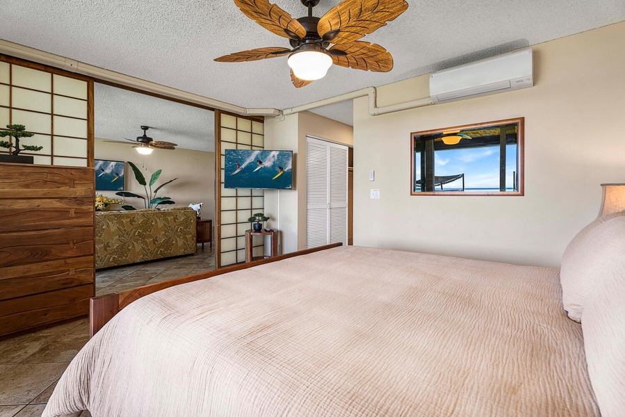 Cozy guest room with cable TV, conveniently located next to the vibrant living area for easy relaxation and entertainment.