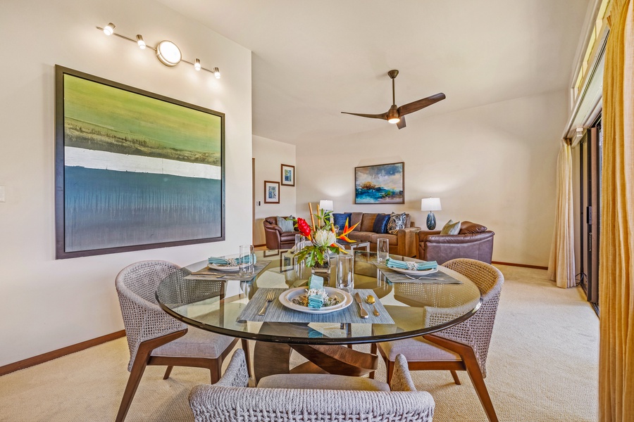 Enjoy meals at the chic glass dining table in Kapalua Ridge 2321, perfect for sharing food and conversation.