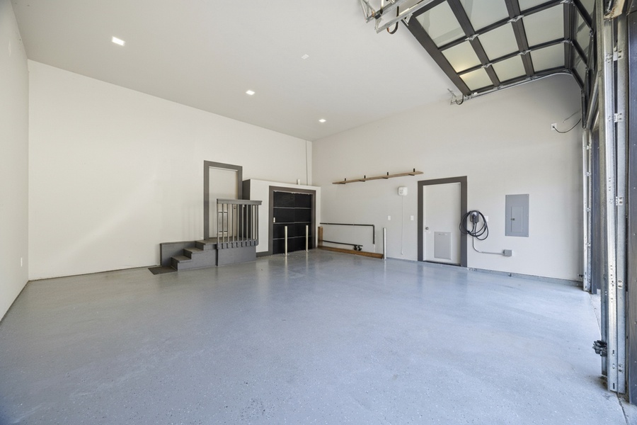 Spacious garage with EV charger access and plenty of storage — ideal for bikes, beach gear, or kayaks.