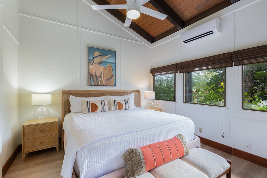 With soaring ceilings and exposed beams, the primary bedroom is a bright and airy retreat for guests of all ages.