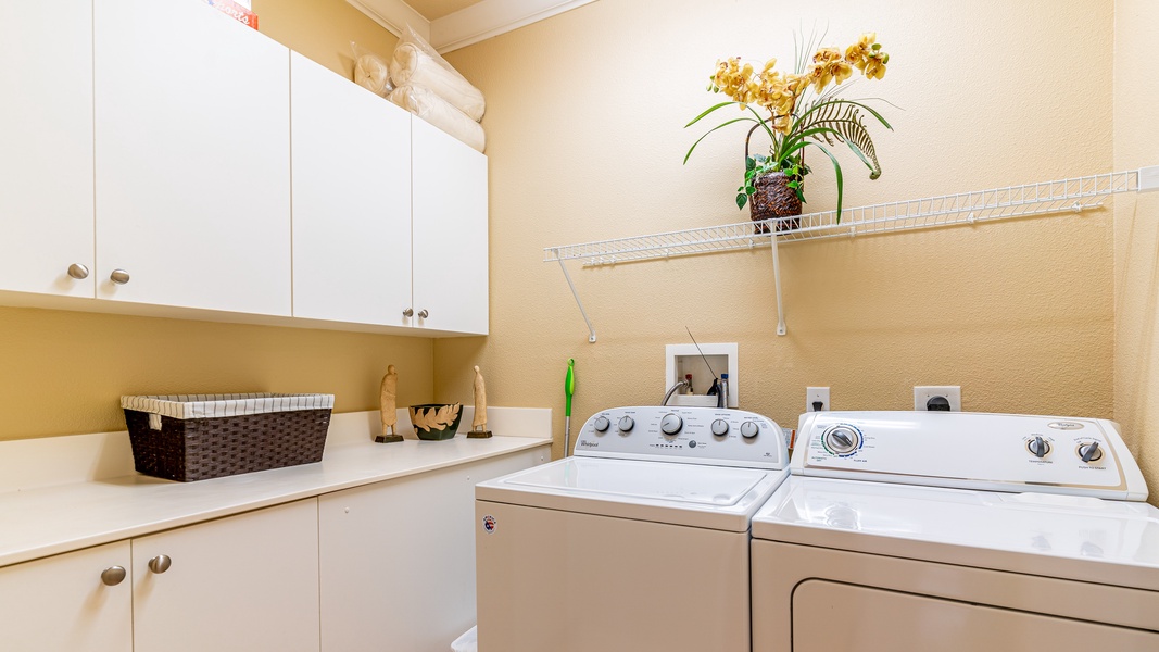 Laundry room with washer, dryer, and cabinetry.