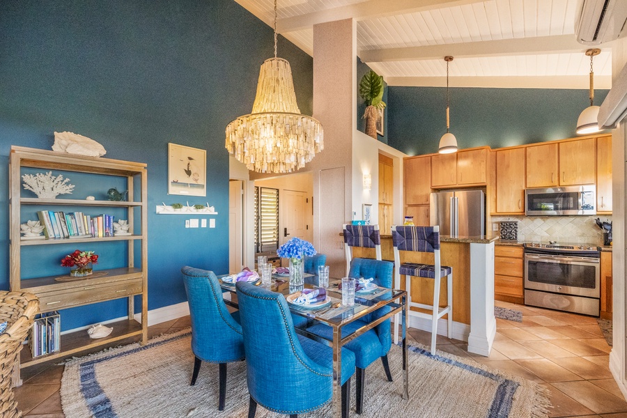 A cozy kitchen area with bar seating, offering a relaxed spot for quick meals or morning coffee while overlooking the tropical views outside.