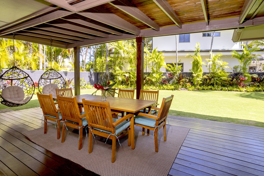 Al-fresco dining in the cozy covered lanai with two swings for outdoor relaxation