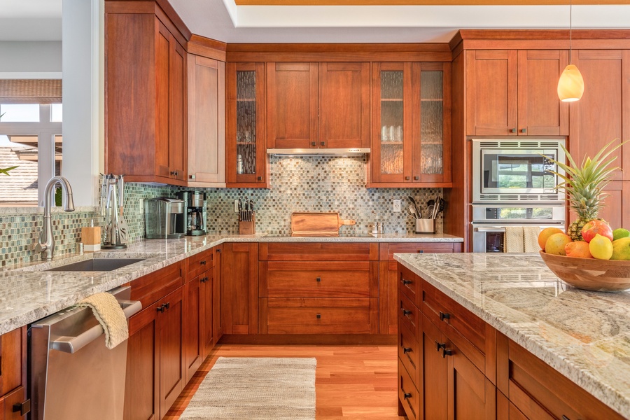 Spacious modern kitchen with large granite island/breakfast bar, granite countertops and elegant finishes.