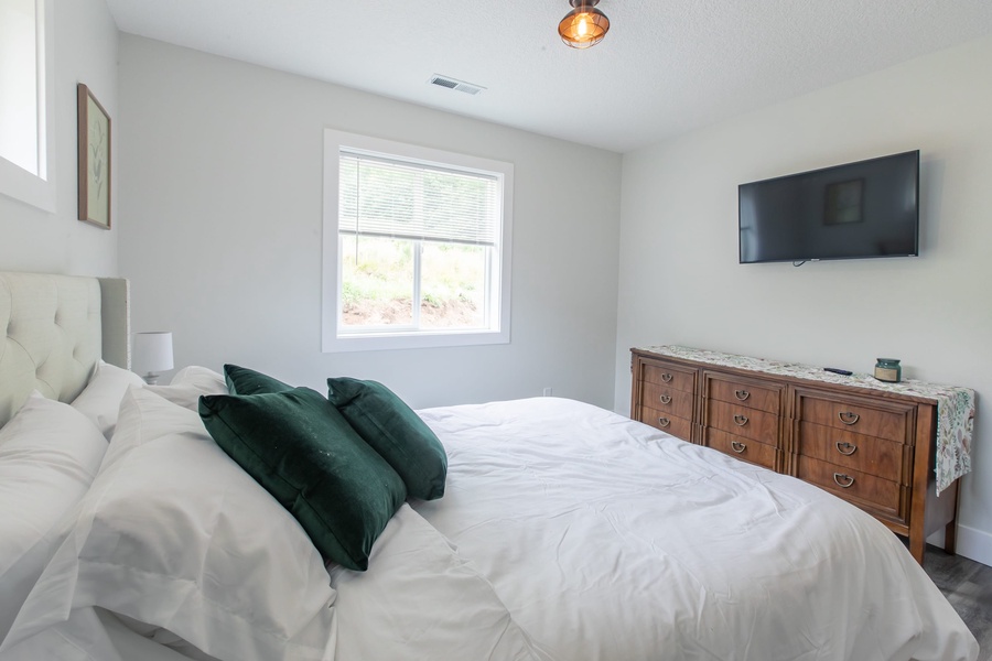 The primary and guest bedrooms each have a comfortable queen bed, flat-screen TV, and closet