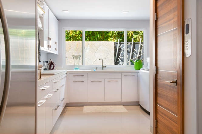 Full laundry room with sink, storage, and washer/dryer—perfect for extended stays or families.