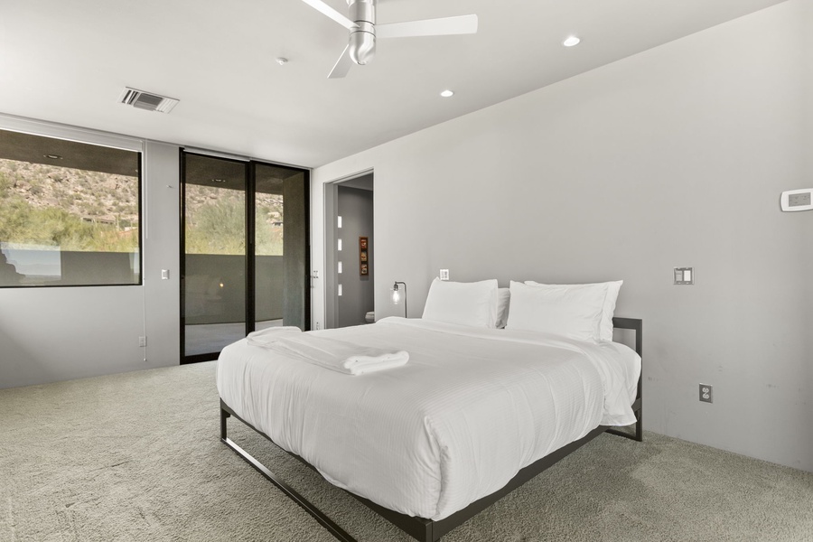Expansive primary suite with a plush king bed and TV