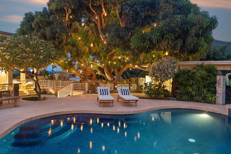Relaxing time at the pool area, under the mango tree beautifully lit at twilight.