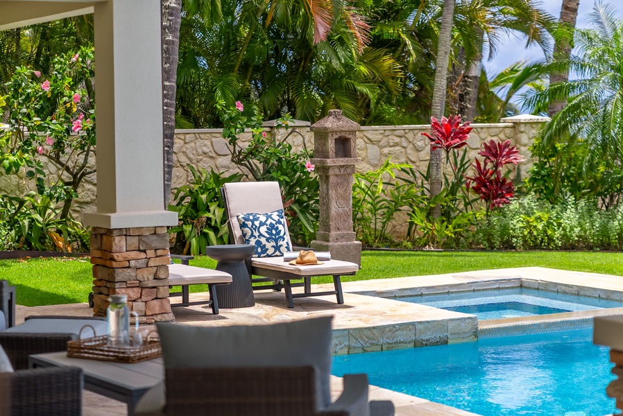 Relax poolside surrounded by lush tropical gardens, vibrant blooms, and swaying palms—your private oasis awaits for sun-soaked afternoons and peaceful moments.