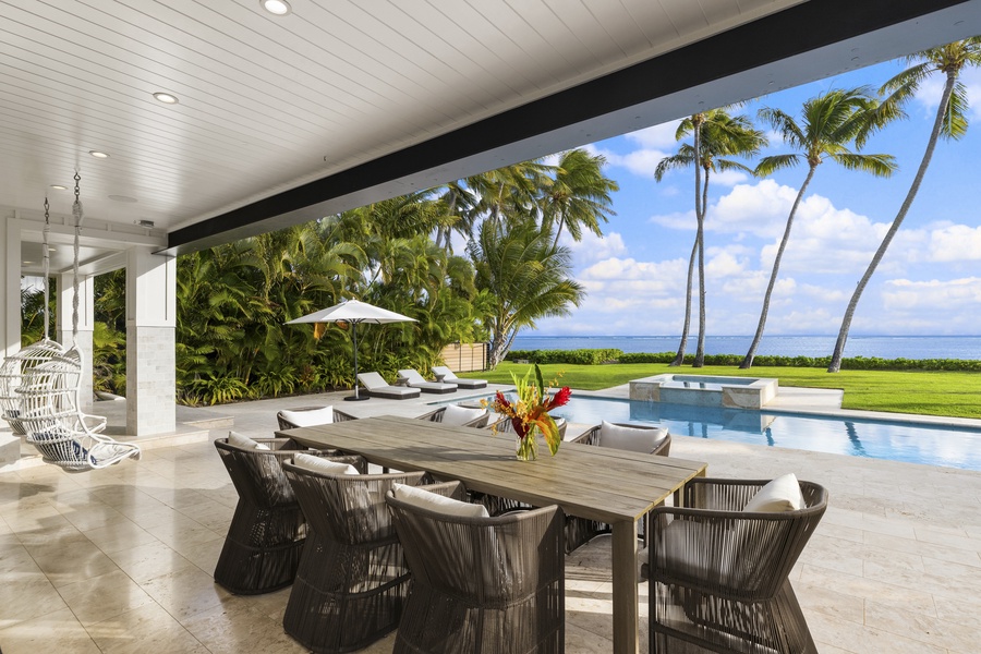 Step out to the enormous lanai to witness the tranquil seaside swimming pool and spa, decorated with chaise lounge chairs and beach umbrellas amidst the manicured tropical flora for relaxing and refreshing fun under the Hawaiian sun