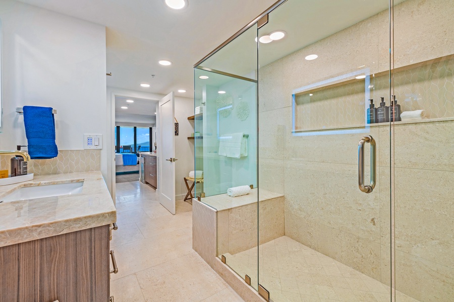 The large walk-in shower in the primary bathroom offers a relaxing and luxurious experience with modern fixtures.