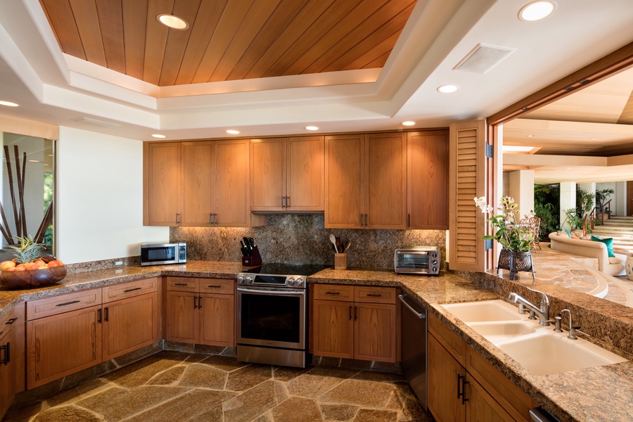 Fully-equipped kitchen with large opening to great room and dining area.